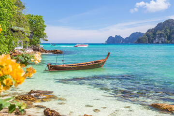 Long-tail boats, the Andaman Sea and hills in Ko Phi Phi Don, Thailand - Powered by Adobe
