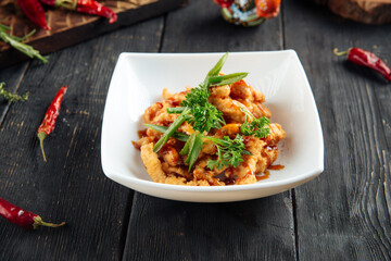 Deep fried asian chicken in a white plate
