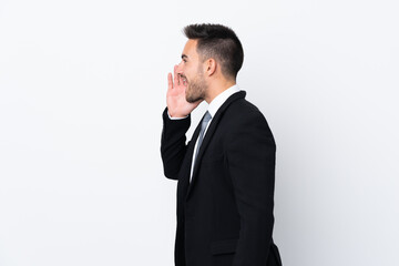 Young business man over isolated background shouting with mouth wide open