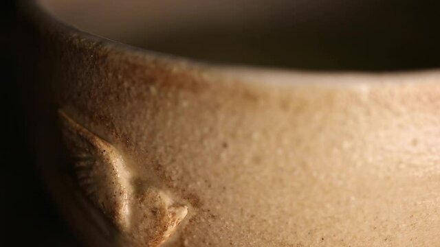 Small cup with a little bird relief on the side.