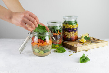 Healthy vegetarian Homemade Mason Jar fresh Salad with Chickpea and Veggies on a light background.Diet, Detox, Clean Eating, Vegan raw food concept.
