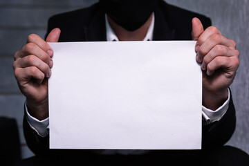 closeup man sitting on stairs and holding paper with text Crisis