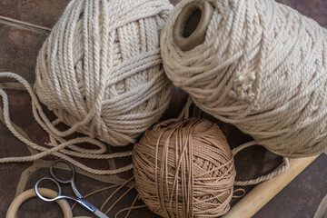 macramé still life detail of rope texture - group of cords and threads with scissors to handcraft...