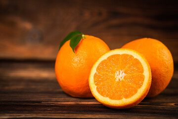 Fresh oranges on old wooden table.