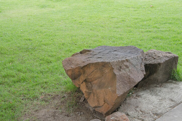 Sandstone seat for sitting beside green lawn