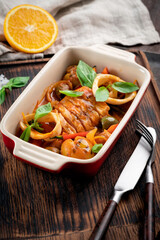 Cod stewed with vegetables and Basil in tomato sauce in a deep dish