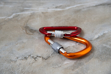 Screw gate carabiners on a marble top © plysuikvv