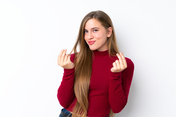 Teenager blonde girl over isolated white background making money gesture