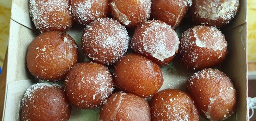 closeup of rusgula gulab jamun with coconut