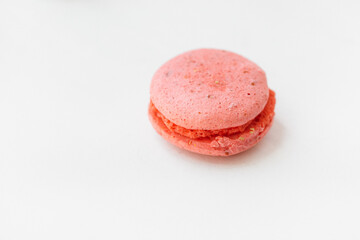 Pink macaroon raspberry cookie isolated on white background. French gluten free  dessert