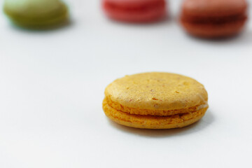 Yellow lemon macaroon cookie isolated on white background. French gluten free dessert
