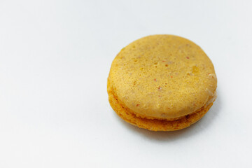 Yellow lemon macaroon cookie isolated on white background. French gluten free dessert