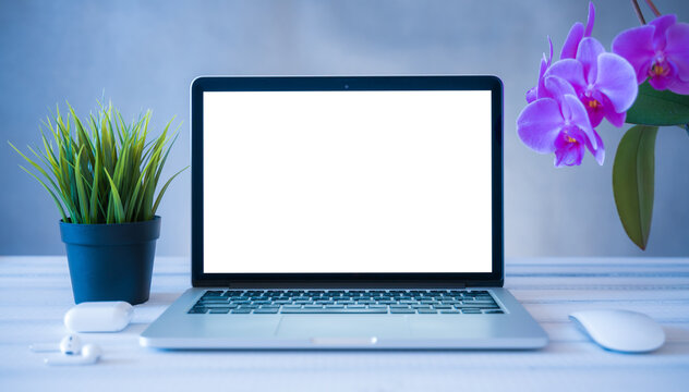 Laptop computer white blank screen on work table front view. Copy space, home and office workspace concept, laptop mockup.