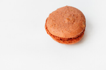 Brown chocolate macaroon cookie isolated on white background. French gluten free dessert