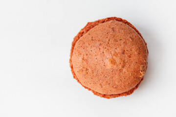 Brown chocolate macaroon cookie isolated on white background. French gluten free dessert