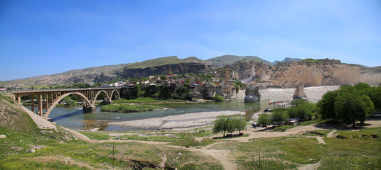 Panoramic view of remains of ancient bridge and modern bridge in town of Hasankeyf, Batman, Turkey. Tigris river.