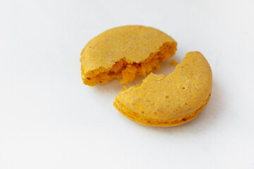 Cracked Yellow lemon macaroon cookie isolated on white background. French gluten free dessert