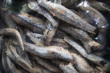 Dried salted anchovies in a transparent package . Snack Fish to beer.  Full frame.