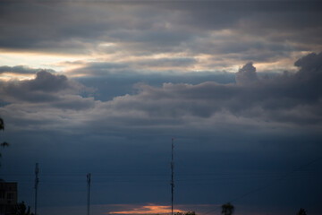 Fluffy clouds cover the summer blue sky
