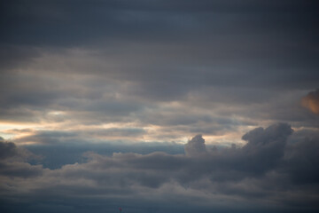 Fluffy clouds cover the summer blue sky