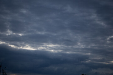 Fluffy clouds cover the summer blue sky