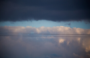 Fluffy clouds cover the summer blue sky