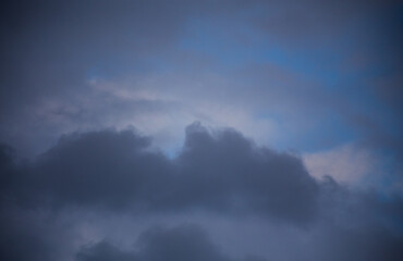 Fluffy clouds cover the summer blue sky