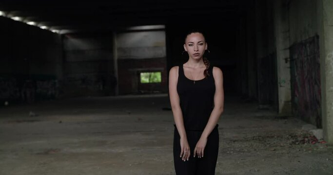 Seductive girl dancing freestyle in abandoned building