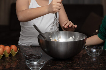 Close-up child`s hands preparing cookies