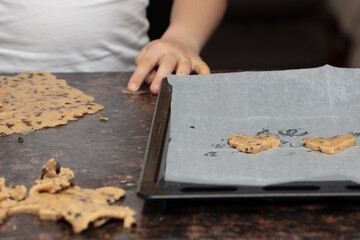 Close-up child`s hands preparing cookies