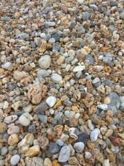 Multi-colored sea pebbles close-up. Greece. Milos island. Summer.