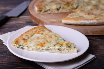 Ossetian pie with cheese and herbs (dill, parsley, scallion). Traditional Ossetian baking.