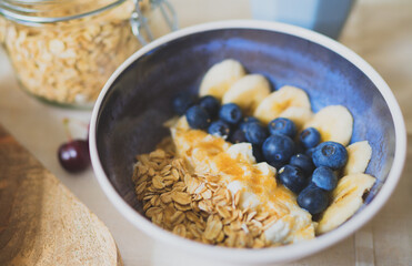 Healthy breakfast with berries, yogurt and oat flakes.
