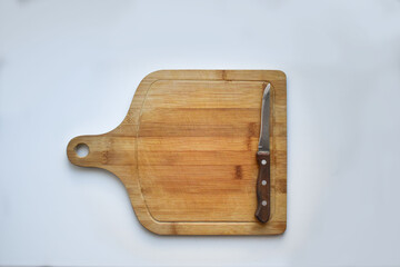 wooden chopping board with a knife