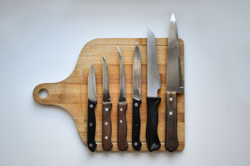 wooden chopping board with knives