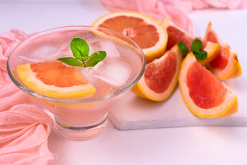 
Grapefruit cocktail with ice and mint on. Close-up.