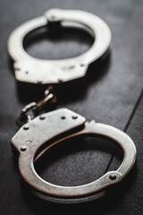 steel metal Handcuffs on brown background
