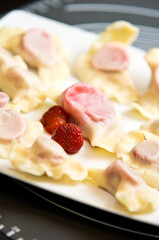 Plate of Polish strawberry dumplings in the kitchen.