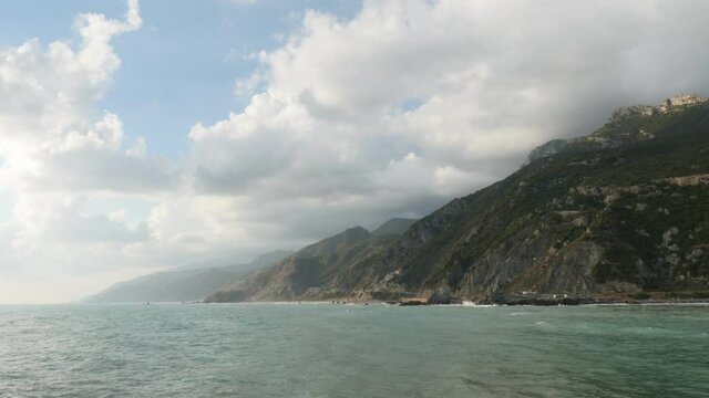 wavy sea and wind on a beach mountain background with clouds hatay samandag keldag turkey syria border