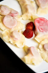 Plate of Polish strawberry dumplings in the kitchen.