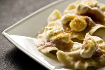 Plate of Polish strawberry dumplings in the kitchen.