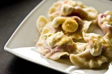 Plate of Polish strawberry dumplings in the kitchen.