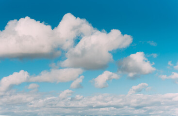 white clouds in a blue sky. Bright day, horizontal photography