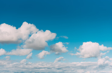 white clouds in a blue sky. Bright day, horizontal photography