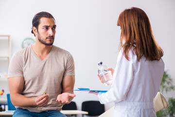 Male diabetic patient visiting young female doctor