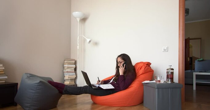 Freelancer using laptop, phone and the Internet. Concept of female business.