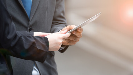 Close up businessman and woman using tablet to work.