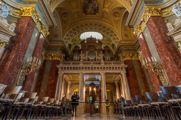 Fototapeta na wymiar Budapest, Hungary - Feb 8, 2020: Organ pipe facade with golden fresco ceiling in St. Stephen's Basilica