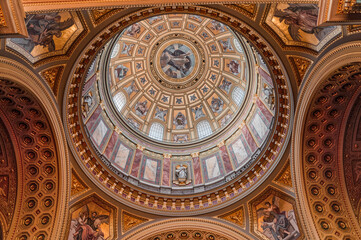 Budapest, Hungary - Feb 8, 2020: Upward view of gilded golden dome cupola inside St. Stephen's Basilica