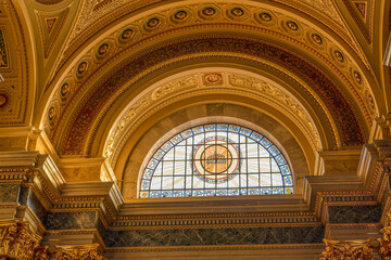Fototapeta premium Budapest, Hungary - Feb 8, 2020: Ceiling view with coronation symbol window in Stephen's Basilica